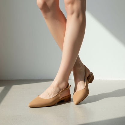 Beige slingback shoes worn by a person on a light gray background