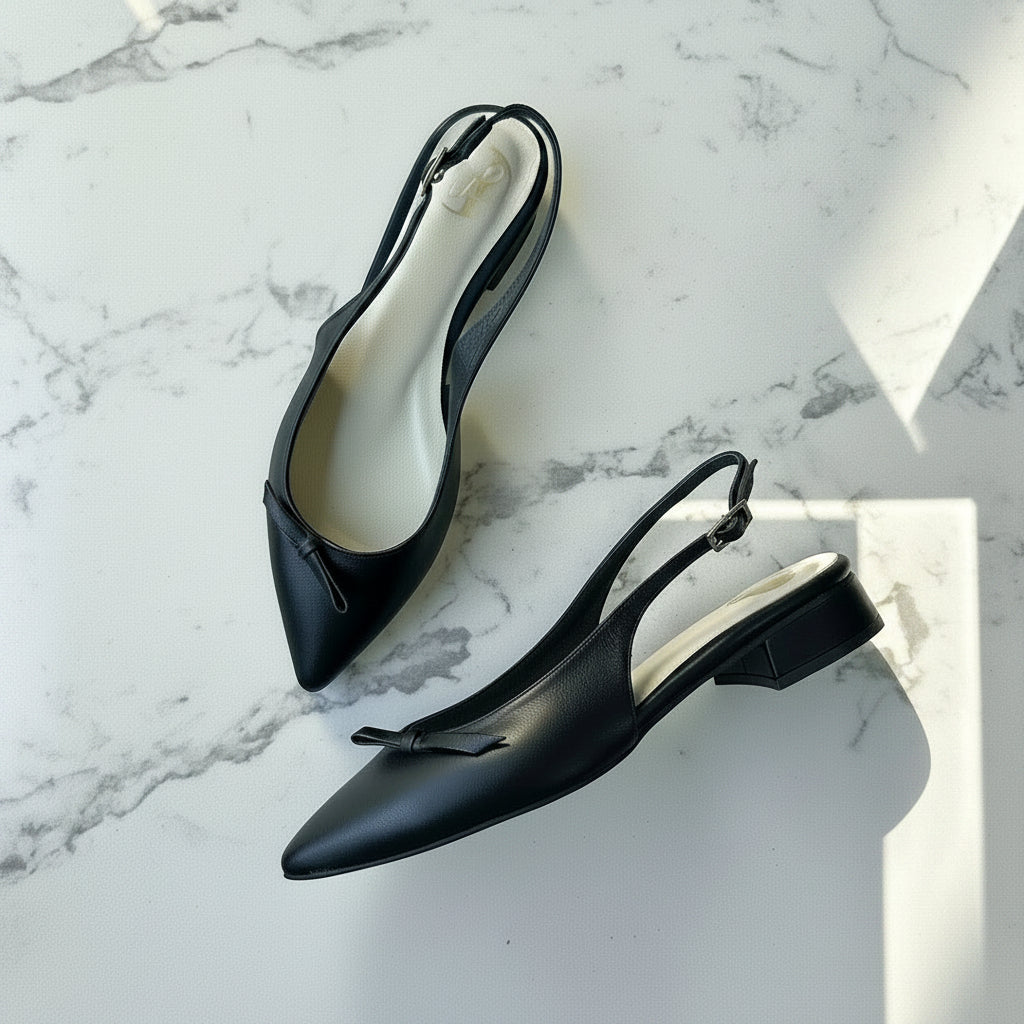 Black slingback shoes on a marble surface