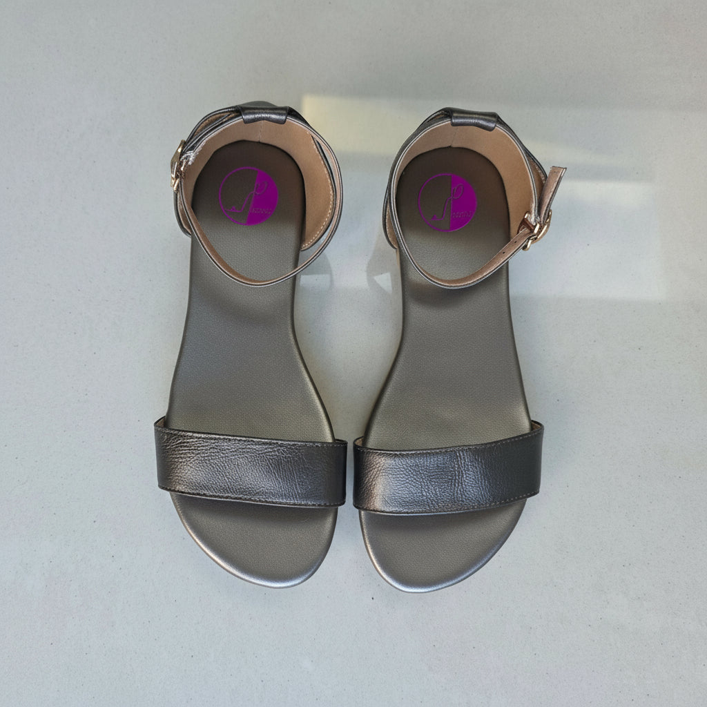 Pair of gray sandals with a purple insole on a light gray background