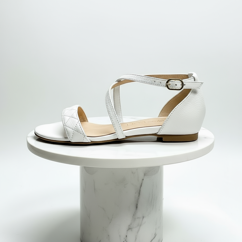 White sandal on a marble pedestal against a light gray background