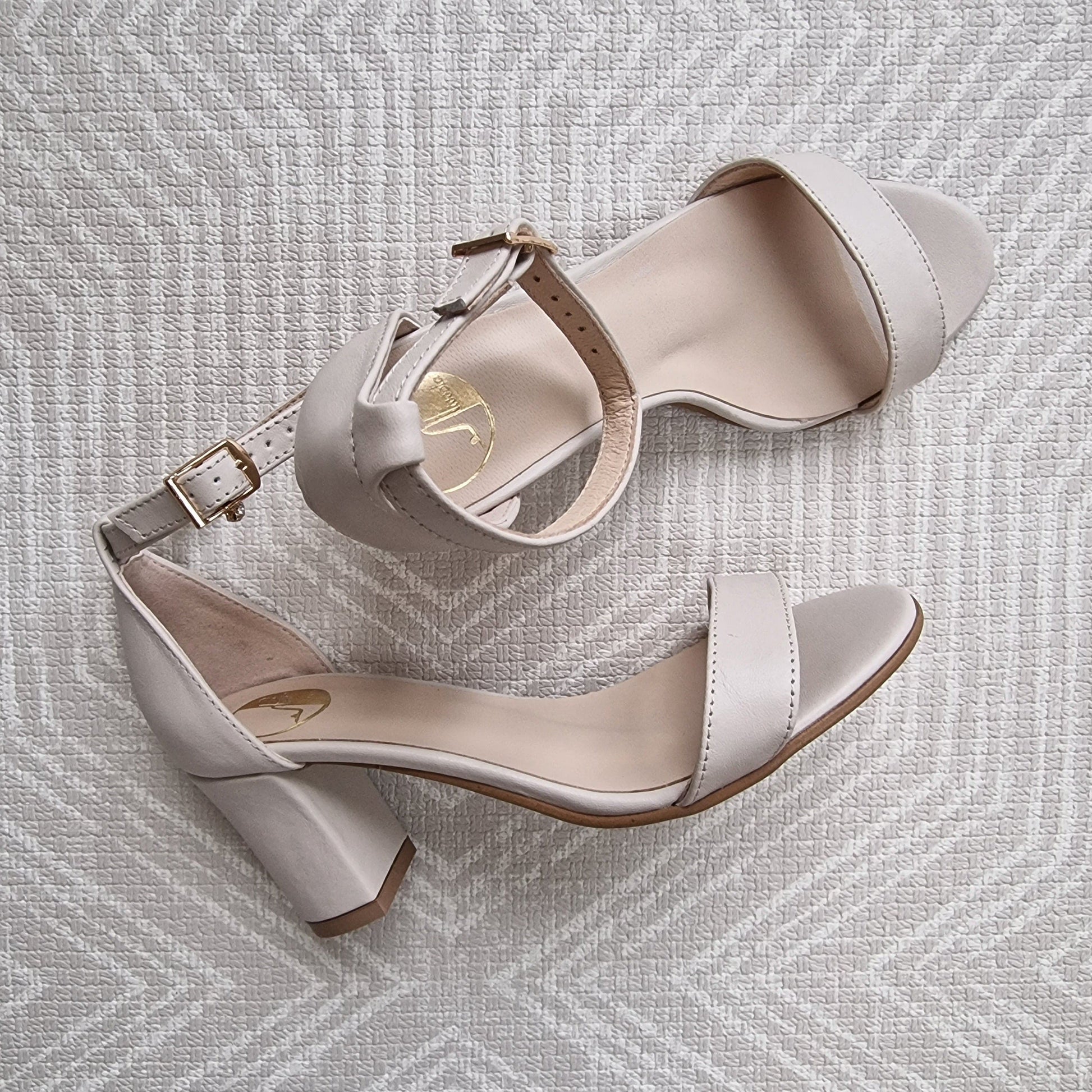 Nude leather ankle strap sandals set on a block heel