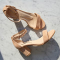 Nude suede leather ankle strap sandals set on a mid heel