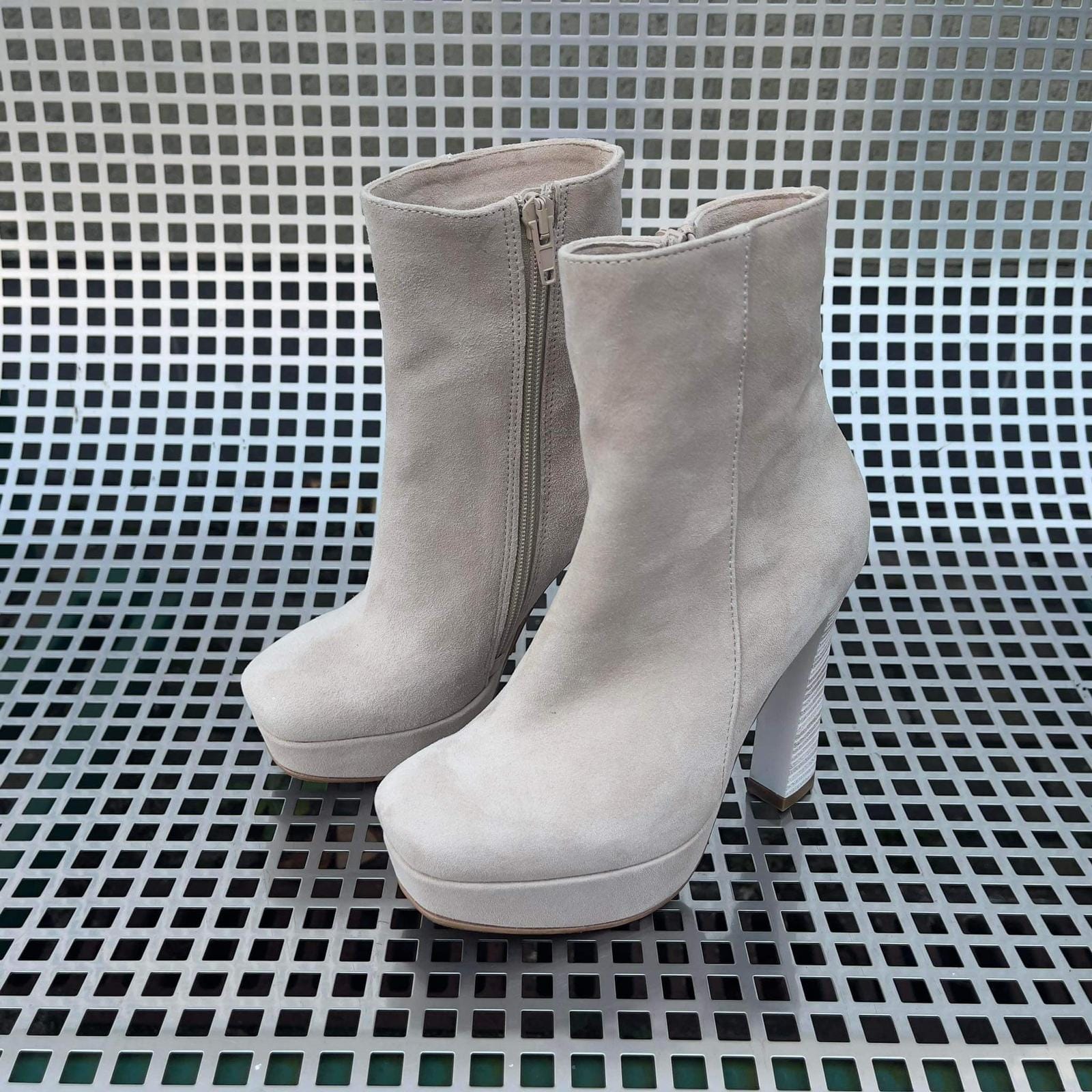 Beige suede platform ankle boots set on a high 4 inch heel