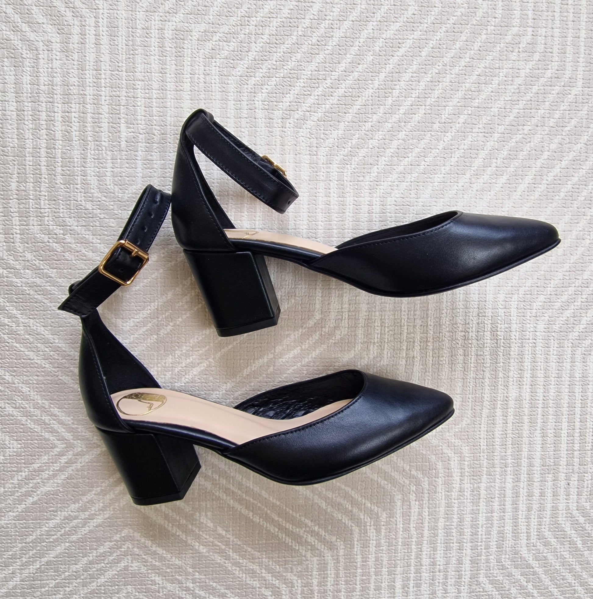 Black leather block heel pointed toe court shoes. 