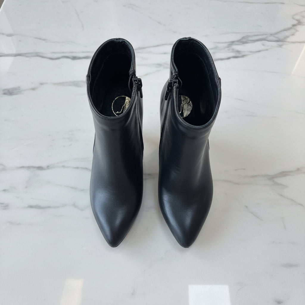Pair of black ankle boots on a marble surface