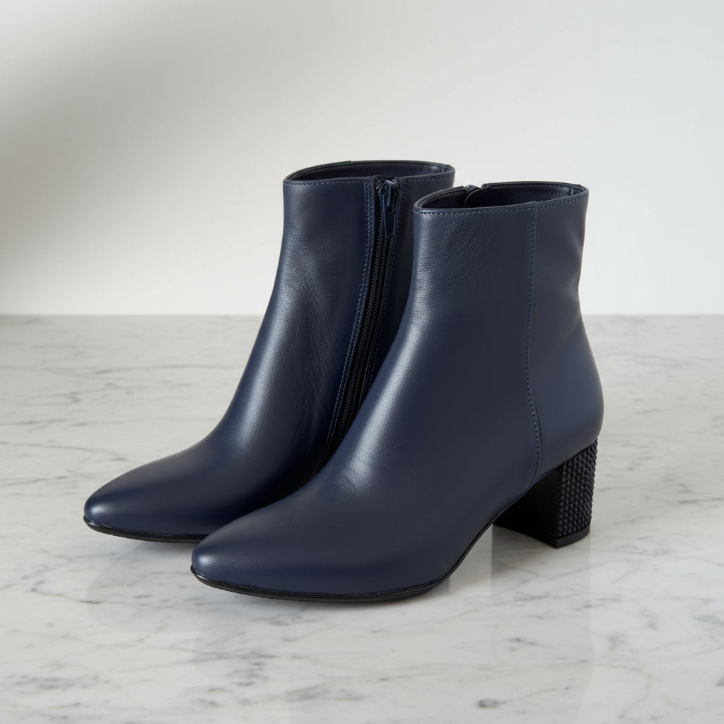 Side profile of REGINA navy leather ankle boots with 6cm studded block heel.