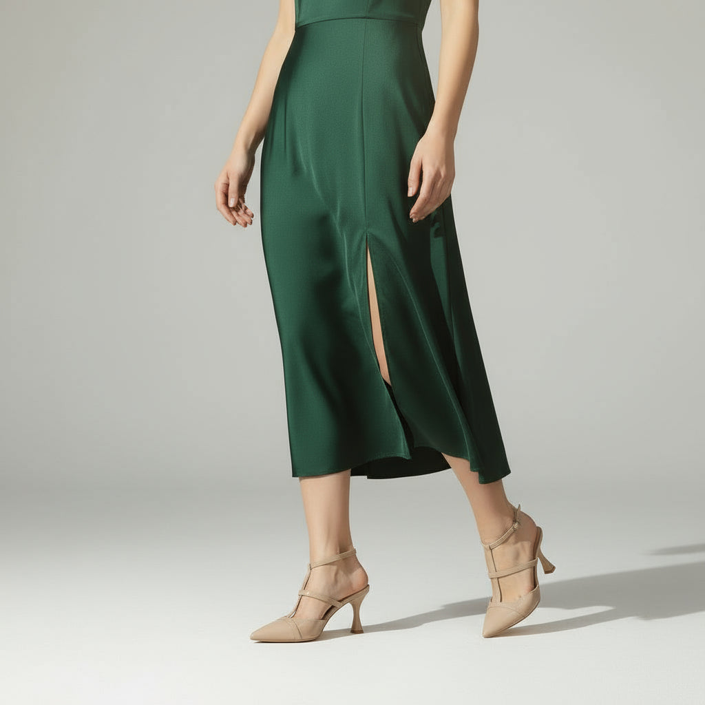 Green dress with a slit on a plain background