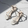 SANTI nude leather sandals with pearls on T-strap displayed on grid, low heel footwear for small sizes