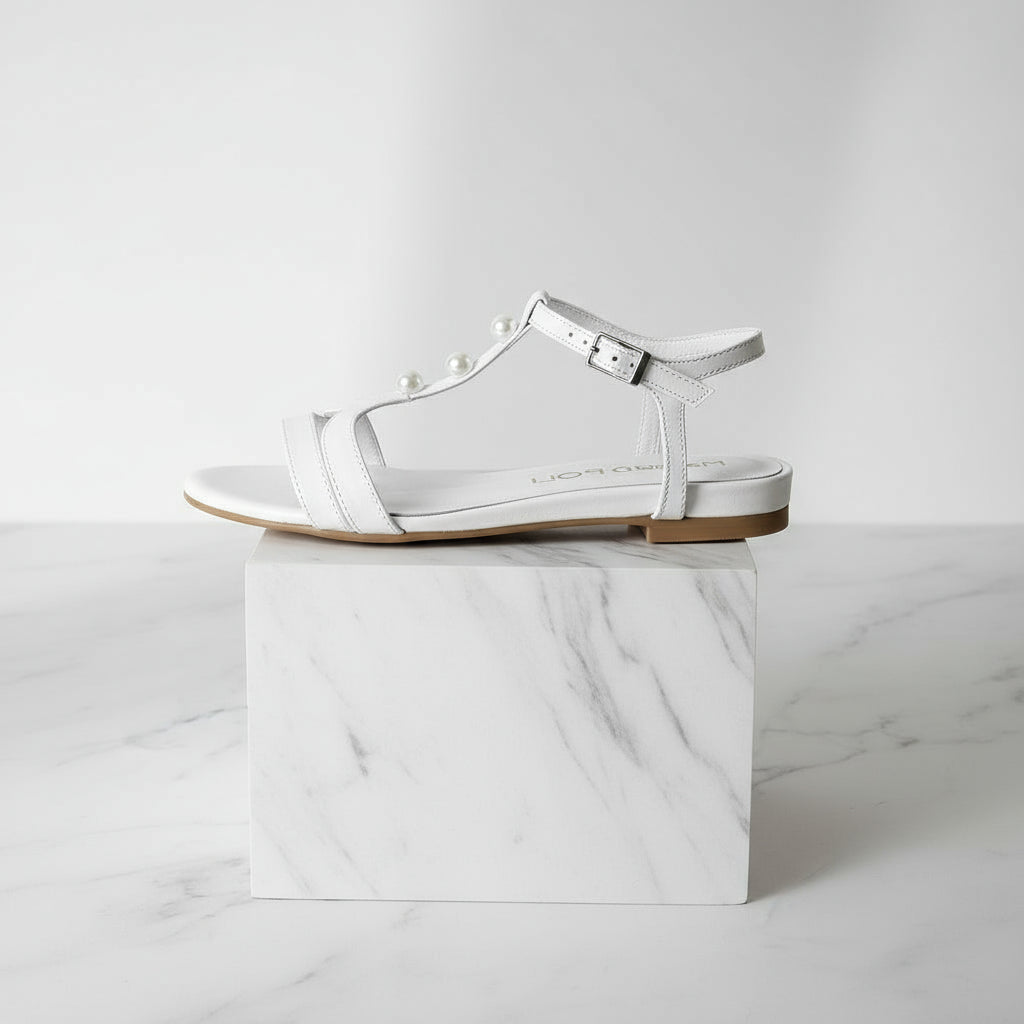 White sandal with clear sole on a white marble block
