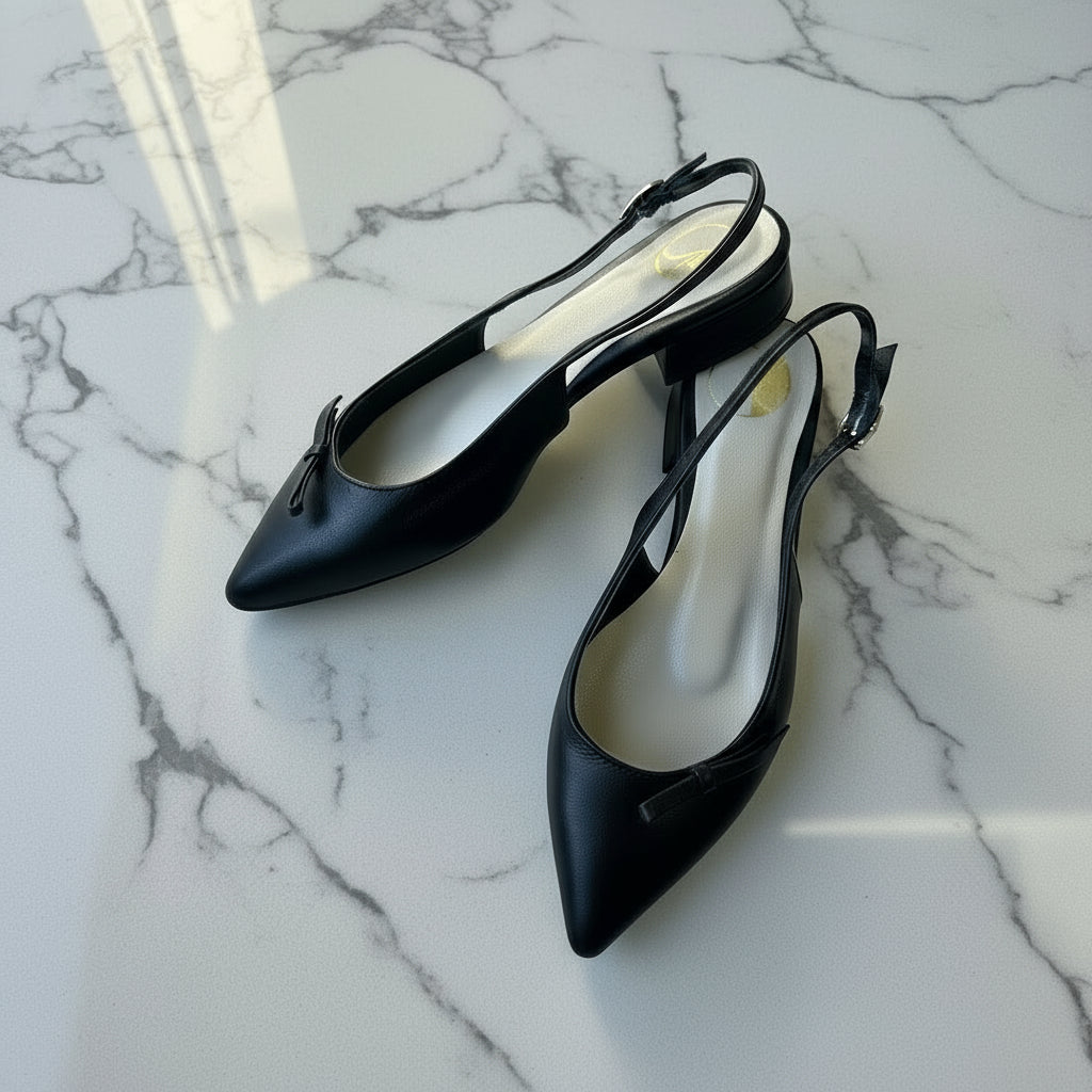Side profile of black leather ANIA slingbacks with slim slingback strap and 2cm block heel.