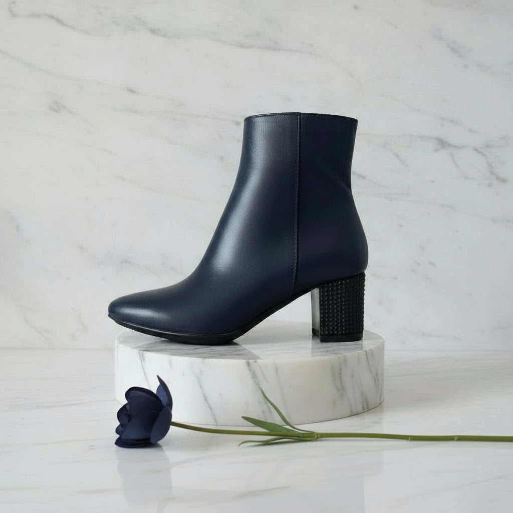 Petite ankle boots in navy leather set on a chunky studded heel.