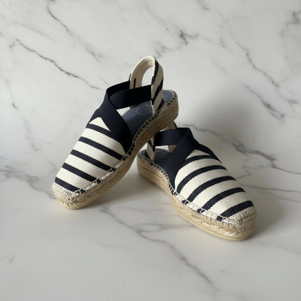 Navy and white striped petite espadrilles on a marble surface