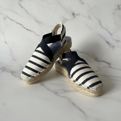 Navy and white striped petite espadrilles on a marble surface