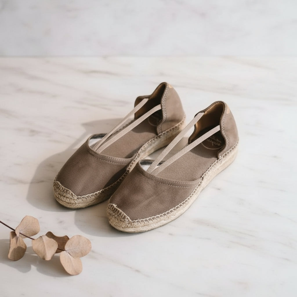 Taupe suede espadrilles with elastic straps styled with natural accessories for women with petite feet.