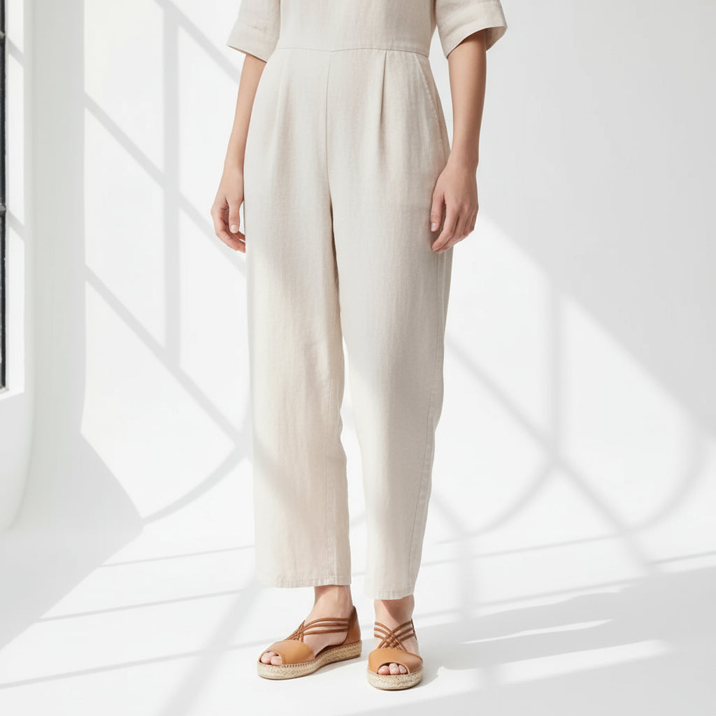 Tan leather espadrille sandals with crisscross elastic straps worn with beige pants, designed for petite feet sizes 1-2.