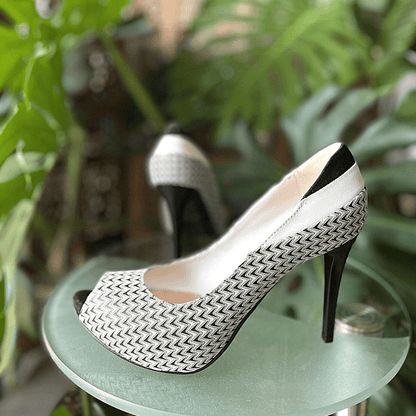Open toe clack and white leather court heels