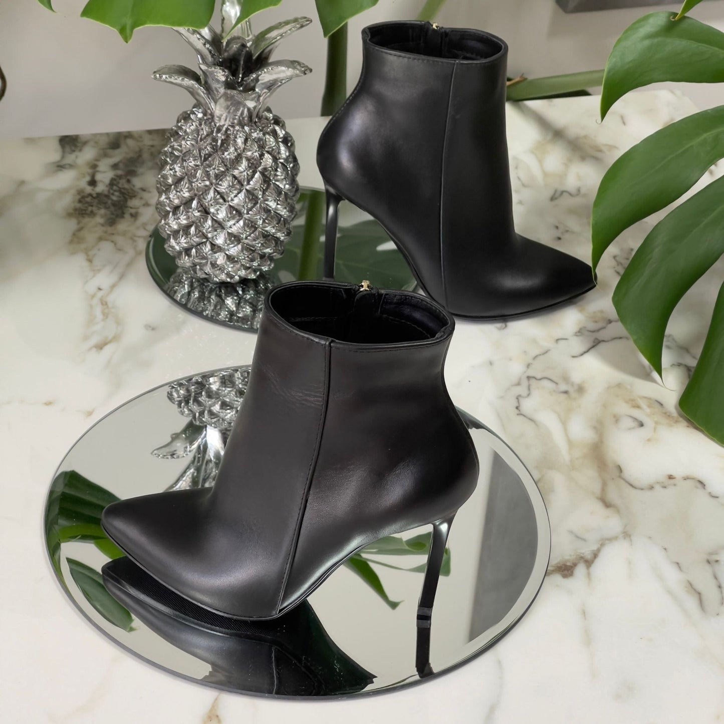 Black leather pointed toe ankle boots