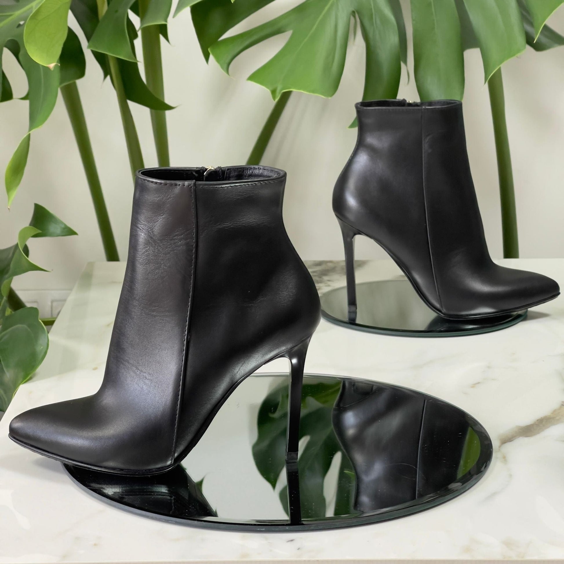 Black leather pointed toe ankle boots