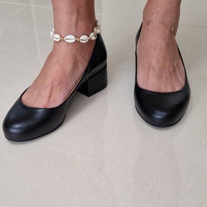 A woman wearing small size kitten keel ballerina shoes