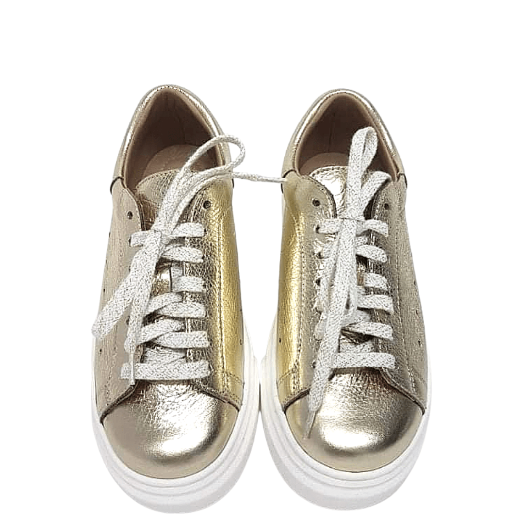 Petite gold leather sneakers set on a chunky white sole
