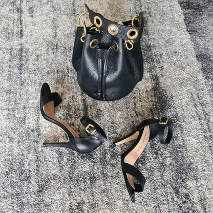 Black strappy sandals and a matching black leather bag with gold detailing