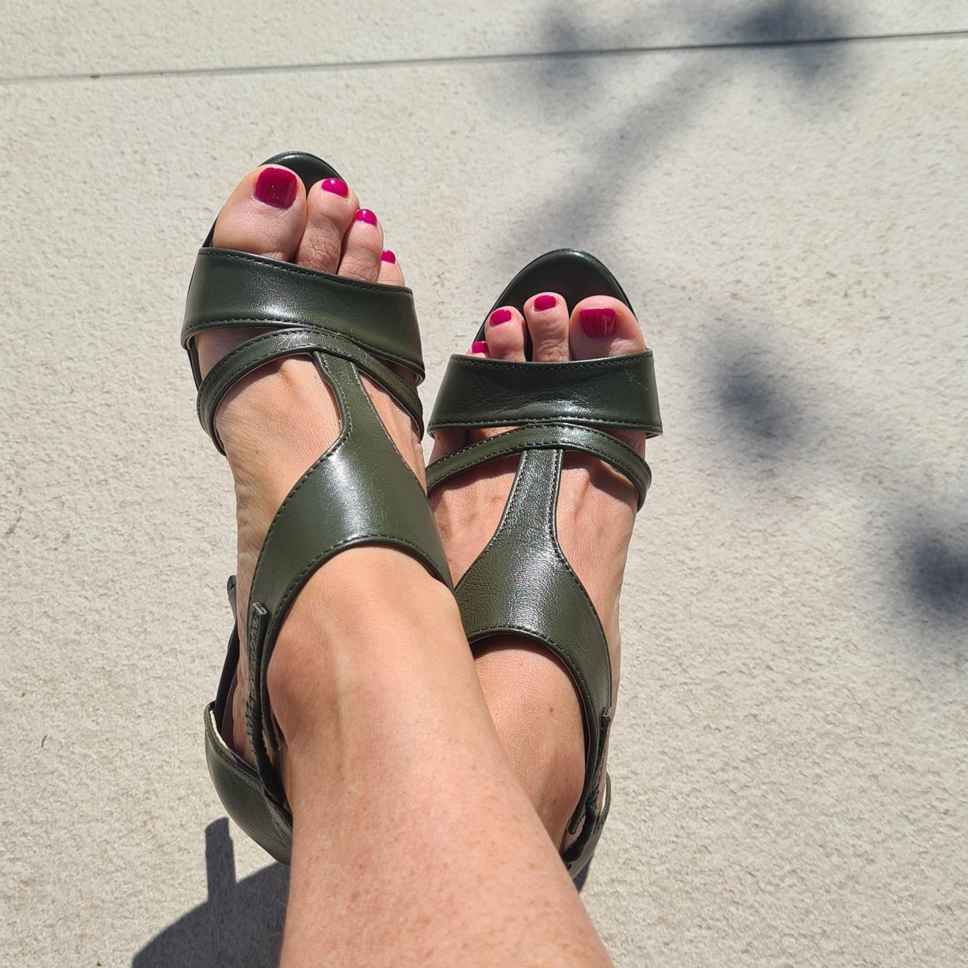 A lady wearing petite green strap sandals