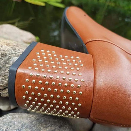 Tan leather boots with a block heel with gold studs