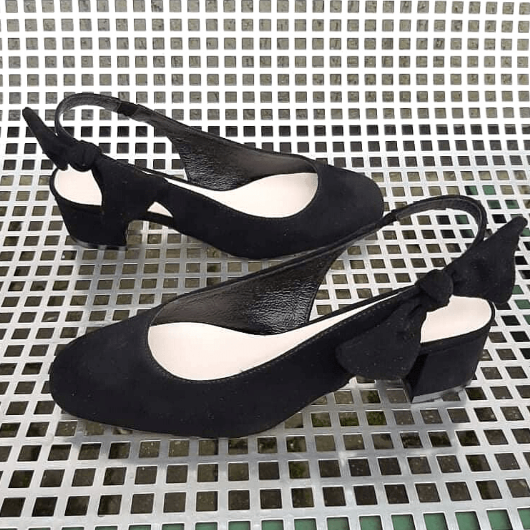 Black slingback shoes with a bow