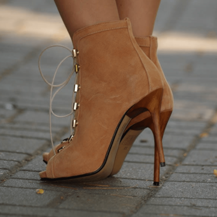 A lady wearing ankle boots in tan suede 
