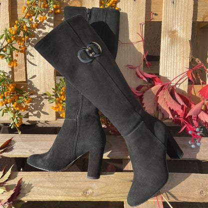 Black suede knee high boots set on a block heel