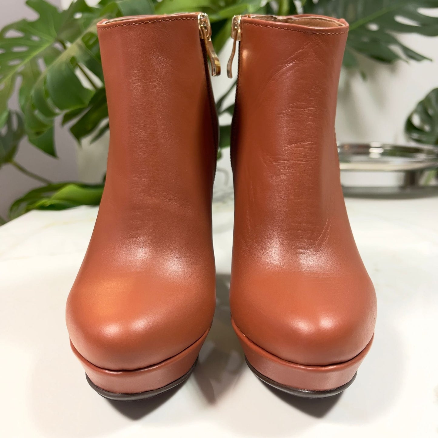 Brown leather ankle boots set on a platform