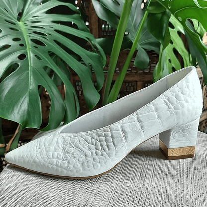 Pointed toe court shoes set on a mid heel in white leather