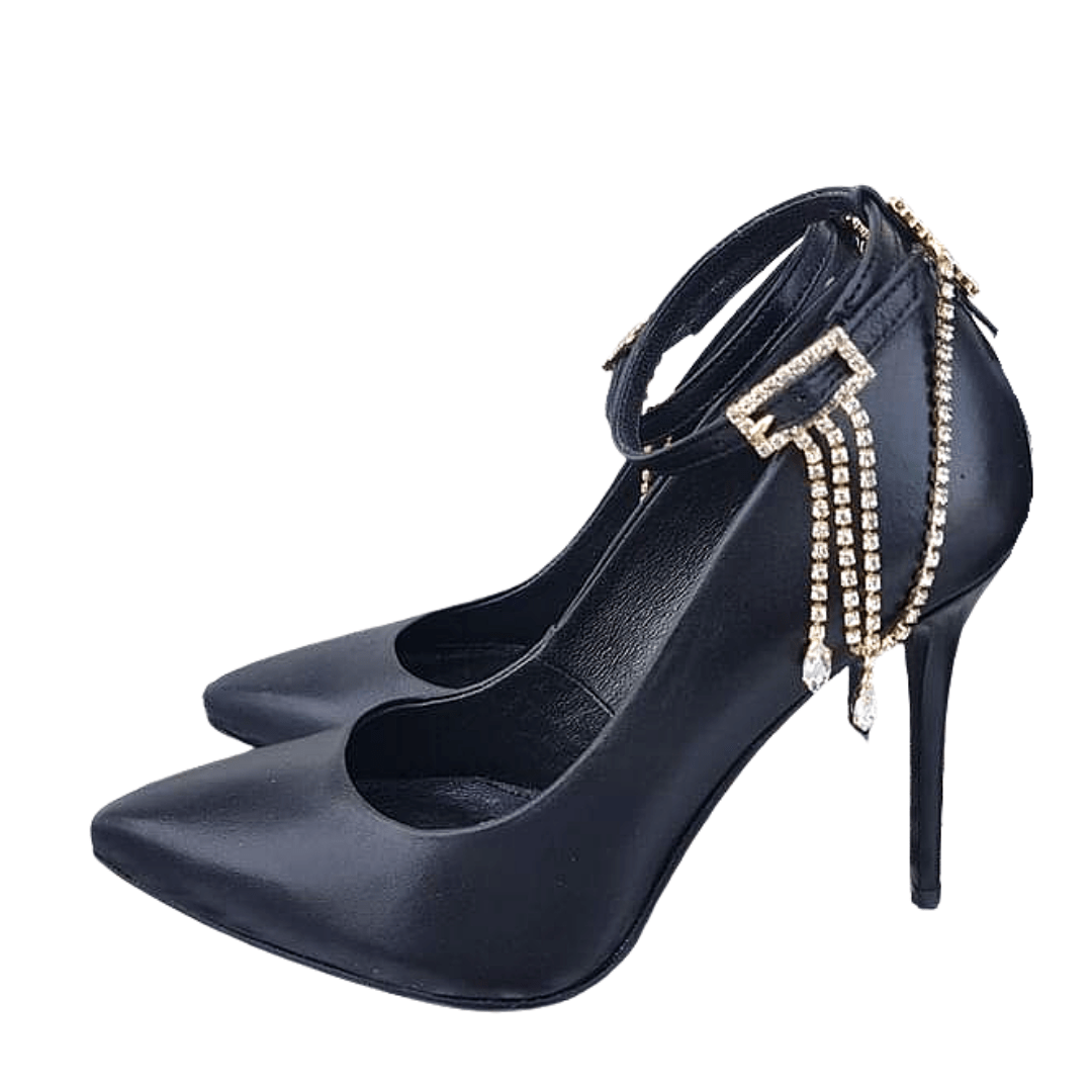 Black ankle strap court heels with a gold chain.