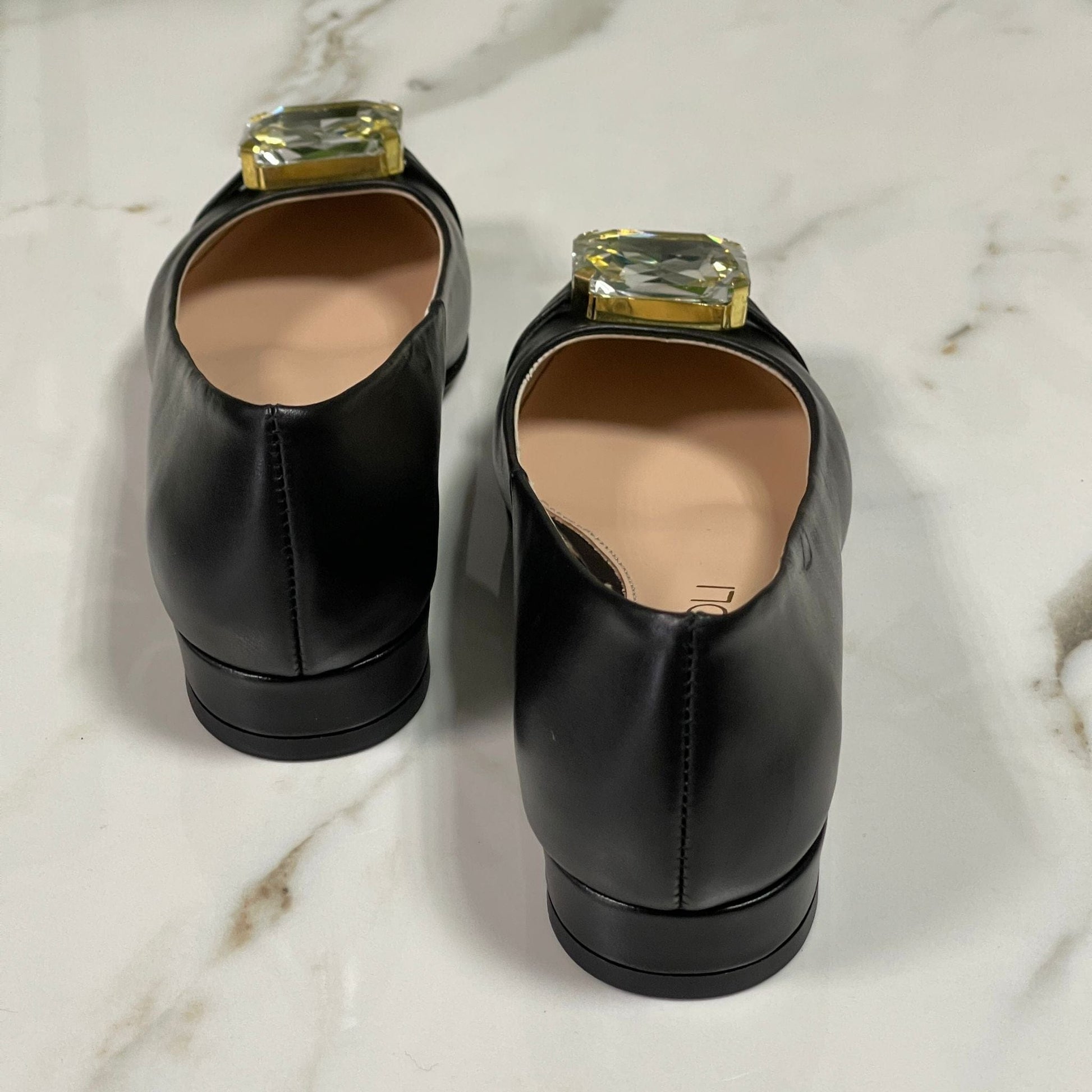 Pointed toe black leather ballerina shoes adorned with a crystal