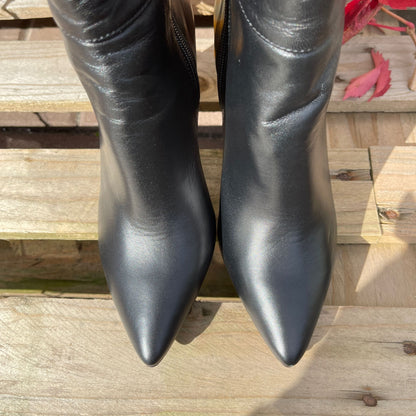 Pointed toe knee high black leather boots