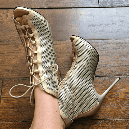 Lady wearing gold leather lace up ankle boots