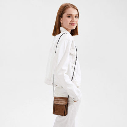 Woman in white wearing a bron shoulder bag.